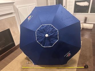 Selling a genuine Tommy Bahama 6-foot beach umbrella in navy blue. Used once.