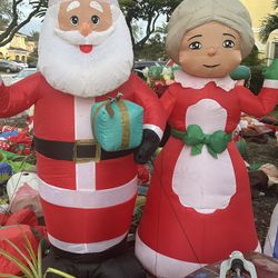 Christmas In Front Of Santa And Mrs. Claus About 7 Feet  sold as a set of two piece