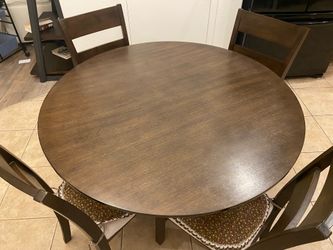 Round dining table with four chairs