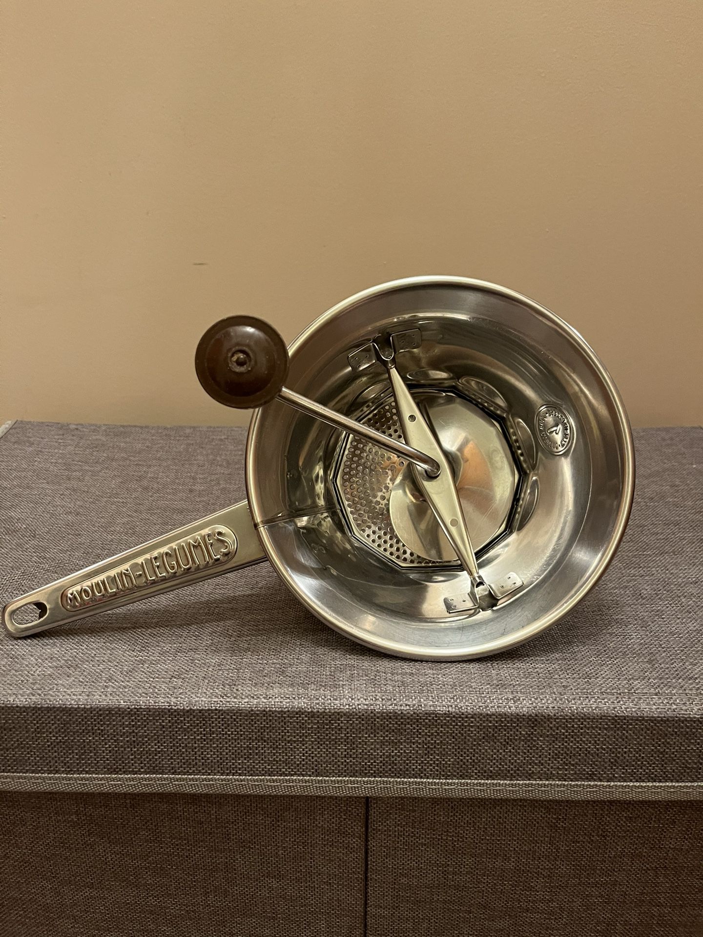This vintage Moulin-Legumes Rotary Food Mill #1 made in France, is a must-have addition to any kitchen. The brown handle adds color and the metal mate