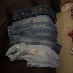 Six Pair Of Jeans And A Polo Hat 