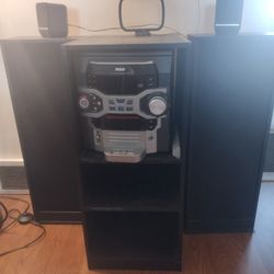 RCA Stereo system with remote, speakers and shelves.