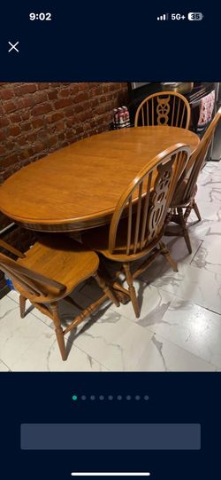 Large solid wood dining table with four chairs