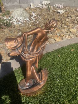 Standing, rose gold woman’s statue