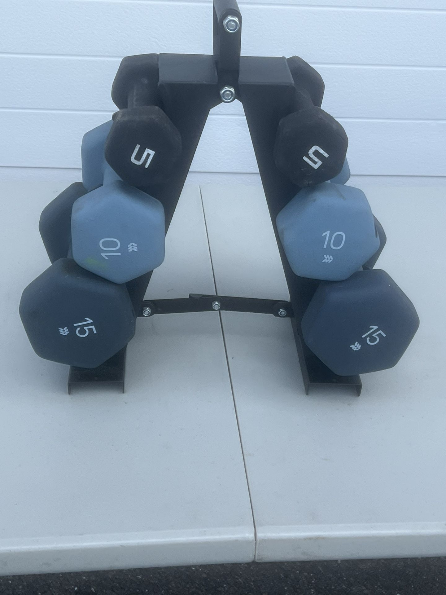 Dumbbell lot with stand 2-15s 2-10s and 2-5s. 5s has a tear in the rubber coating. 60lbs total. Location below 31705 SR-54 Wesley Chapel, FL 33545