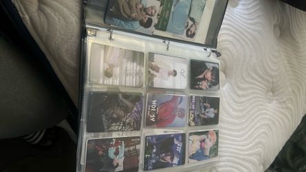 Binder full of Stray Kids posters and poster cards