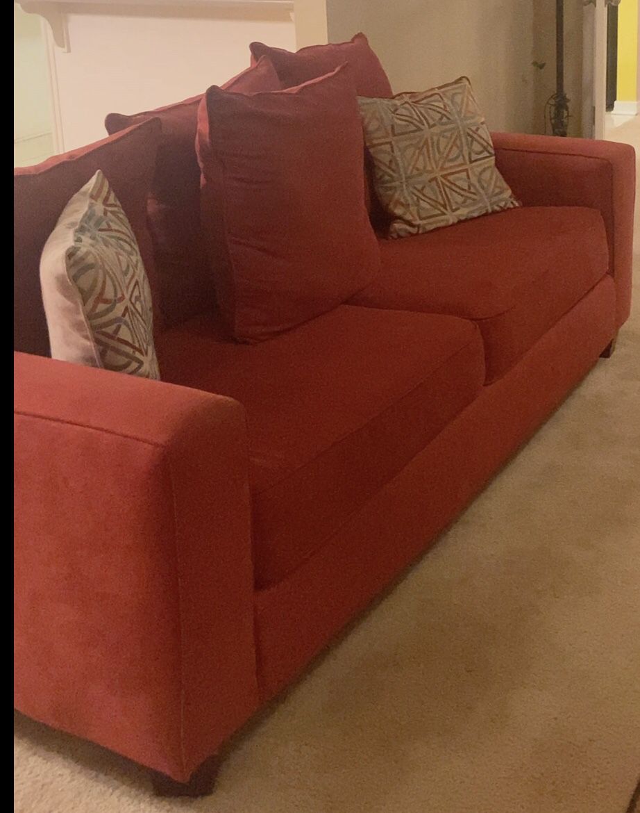 Orange comfortable couch Includes 2 Pillows