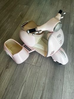 Pink toy scooter with sidecar.