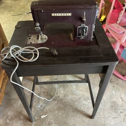 This is a vintage Kenmore sewing machine, likely from the mid-20th century, which is built into its own cabinet. Width 2ft., height 2ft. 6”.