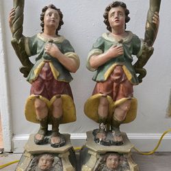pair of polychrome carved wooden figural candleholders,