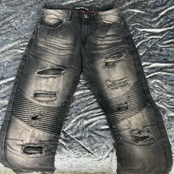 Black distressed  jeans with knee and leg holes 