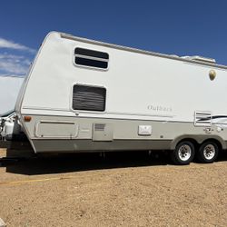 2004 Keystone Outback 26RS bunk house  a rear slide queen bed, a quad bunkhouse, and a dinette and couch that fold down, there is plenty of sleeping r