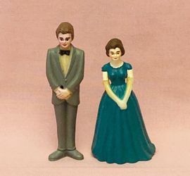 Pair of vintage cake toppers man in tuxedo and woman in green gown plastic