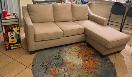 Beige couch with reversible ottoman