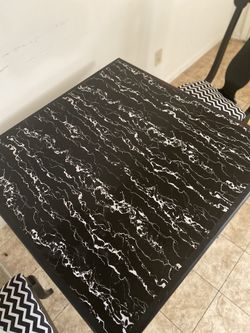 Black and white marble top dinning table with 4 chairs