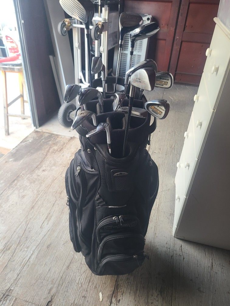 Dunlop Resolve golf club set with a couple hybrids and a putter in a bag. LEFT HANDED