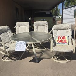 Glass Top Table And 4 Swivel Rocker Chairs.
