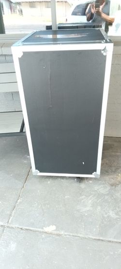 Heavy duty road / freightcase with metal edges and corners also has five Wheels for for transportation one to swing the front door open.