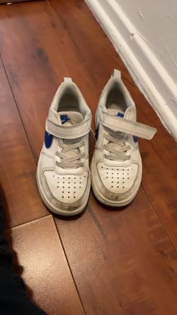 White Nikes with blue check mark