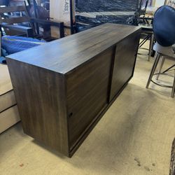 Dark walnut-finish media cabinet or TV console featuring sliding doors - 60” x 18” x 30” H