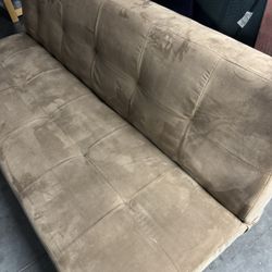 Brown tufted convertible futon sofa bed.  