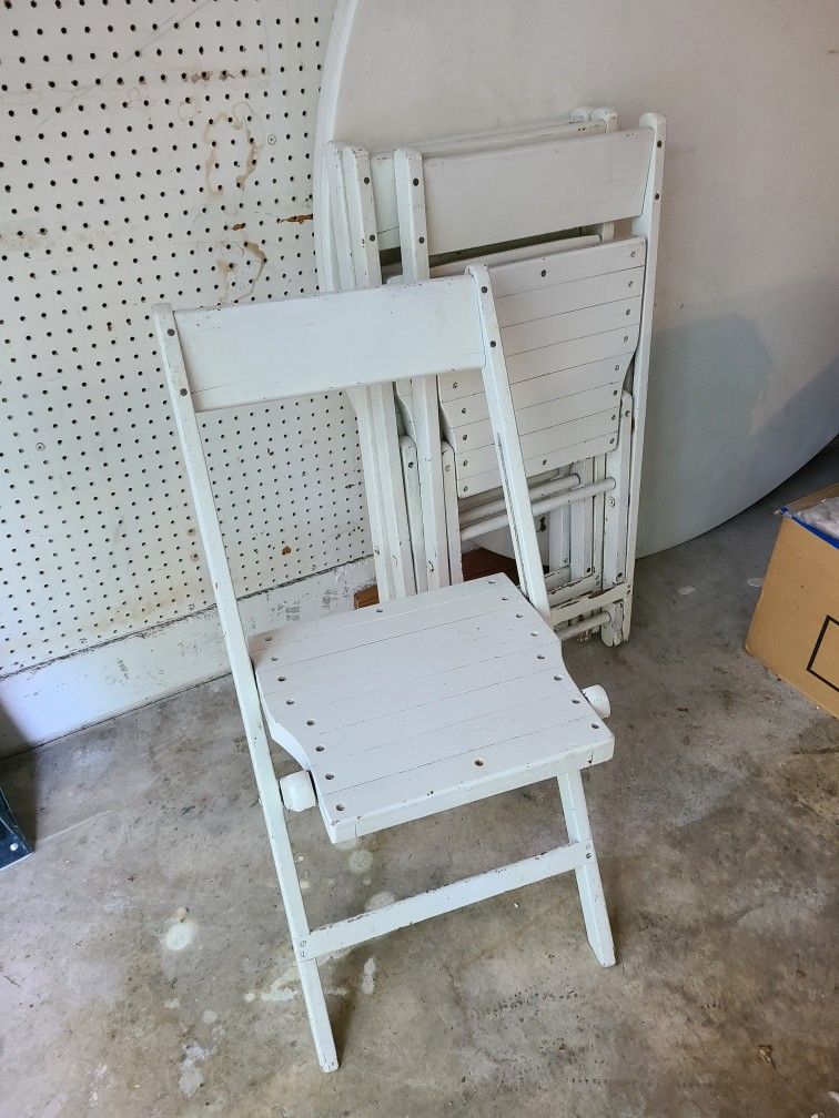 4 White wood folding chairs