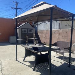 Outdoor Canopy, Table, and Wicker Bench
