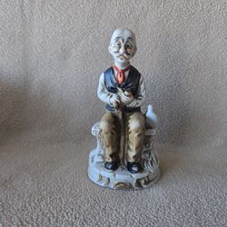 Old man sitting with his cane and pipe