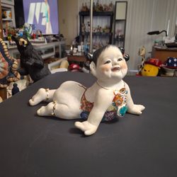 Vintage Mid 20th Century Chinese Porcelain Crawling "Piano Baby" Depicting A Young Girl, Hand-painted In Vibrant Colors W/Gold Accents, Represents Pur