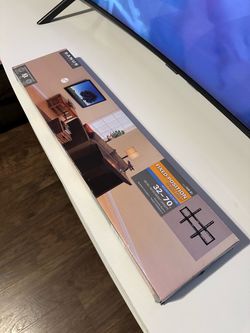 Low-profile wall mount; fits most 32"–70" flat-panel TVs.