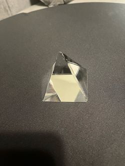 Faceted clear glass crystal. Cool geometric shape. Good for desk decor or as a paperweight.