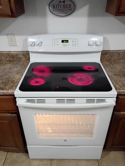 GE, WHITE ELECTRIC STOVE.