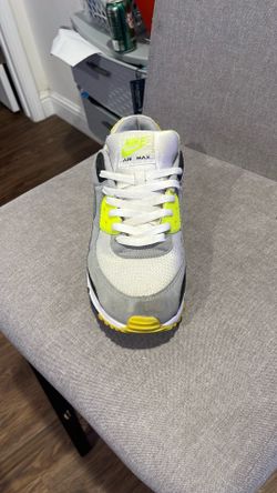 Nike Air Max 90 sneakers in a White, Particle Grey, and Volt colorway