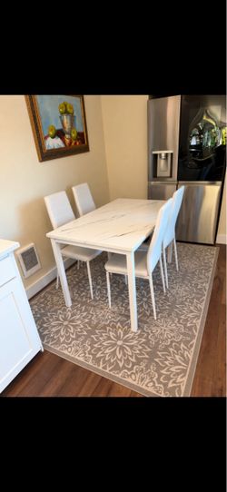 Table and chairs with rug
