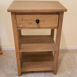 Sturdy wooden nightstand with one drawer and two shelves.
