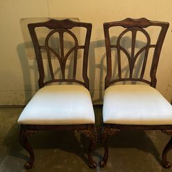 Two Wood Chairs With White Upholstered Seat