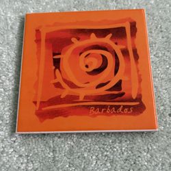 Coaster With A Design Of A Spiral And The Word Barbados Printed On It 4“ X 4“