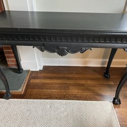 Black Distressed Console Table in Very Good Condition Shell detailing and claw feet. Measures 20”d x 50”w x 32”h. Smoke and pet free household