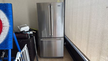 Silver Maytag refrigerator, full-size kitchen appliance, used condition.