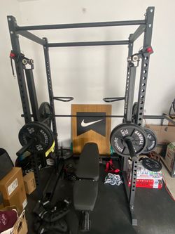 Power Rack with Barbell, Weights, and Bench + more