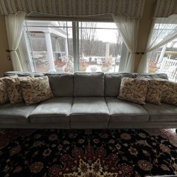Gray Sofa With Nailhead Trim And Pillows
