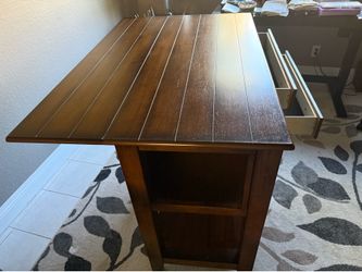 Wooden drop leaf table with drawers and storage