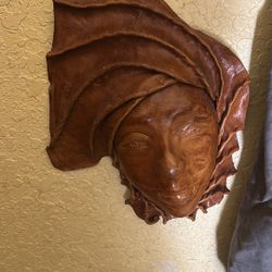 Leather face hangs on wall