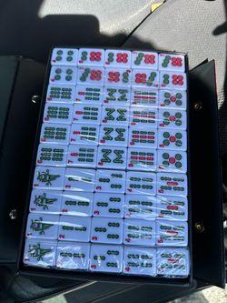 YMI Rouge Oasis Chinese Mahjong Set, 146 Small Tiles 146 engraved melamine tiles with bamboo motifs in a red vinyl case, plus dice and wind indicator.