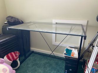 glass desk, black metal legs and glass desktop.