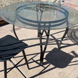 Glass Table Rod Iron Bottom And Two Metal Black Chairs For Sale