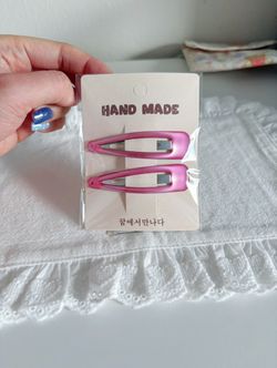 A pair of pink hair clips