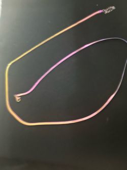23 Inch Vibrant iridescent Rainbow Stainless Steel chain necklace with a flat, flexible design. This piece has a multi-colored rainbow finish that shi