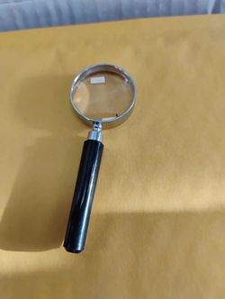 3" classic-style handheld magnifying glass with a silver-plated or chrome-plated metal frame and a black handle.