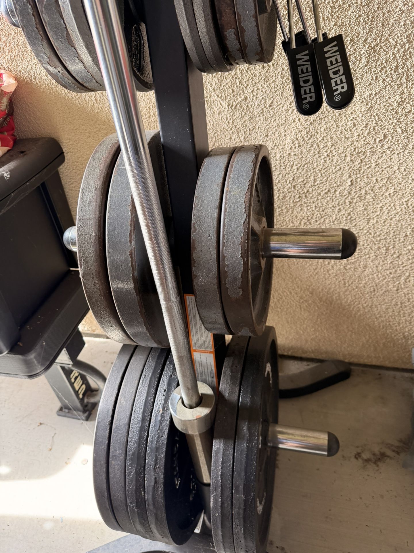 Weight plates, rack and barbell.